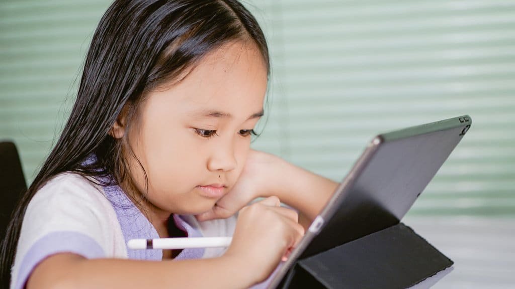 A child using a tablet app alone to practice a language